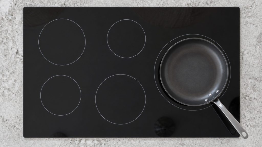 a 36-inch induction cooktop seen straight down, five zones printed as plain rings — the 36-inch induction