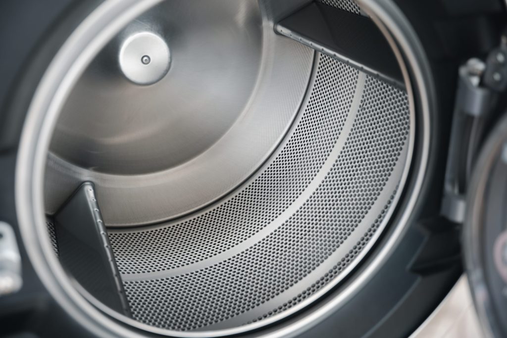 the inside of a dryer drum, the perforated stainless wall and the lifting vanes